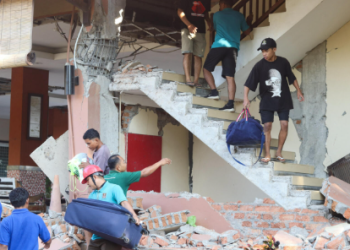 Residents in Flores seek food, water and shelter after a 7.7-magnitude earthquake leaves thousands displaced and awaiting emergency aid.