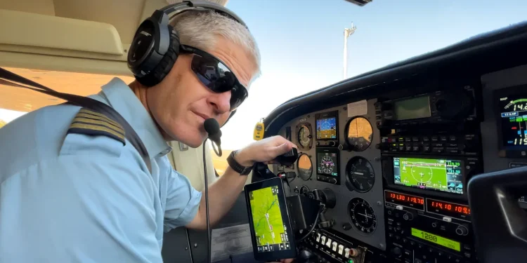 Kevin Rideout makes preflight checks before transporting a team from Hope Springs International in Niger.