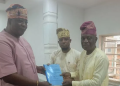 General Secretary of the Fusengbuwa Ruling House, Prince Adeleke Adeyemi receives the 25-page report of the nine-member Fact-Finding Committee from the committee's chairman, Prince Olusegun Olusoga and Secretary, Adeyemo Oduneye.