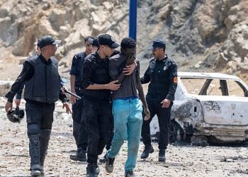 Moroccan security forces detain a man who was trying to cross from Fnideq into the Spanish enclave of Ceuta