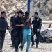 Moroccan security forces detain a man who was trying to cross from Fnideq into the Spanish enclave of Ceuta