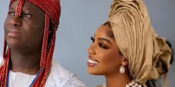 The Ooni of Ife and his wife, Olori Oluwatosin, pose for a photograph