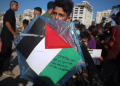 Palestinian children hold kites during a gathering at Gaza Port on August 25, 2026