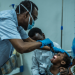 A pediatrician examines a young child’s throat and tonsils as Kano State moves to contain reported diphtheria outbreak.