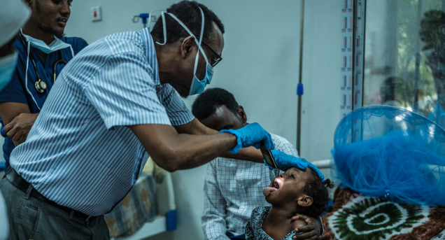 A pediatrician examines a young child’s throat and tonsils as Kano State moves to contain reported diphtheria outbreak.