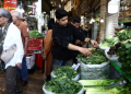 People shop at a market, amid the US-Israel conflict with Iran, in Tehran, Iran