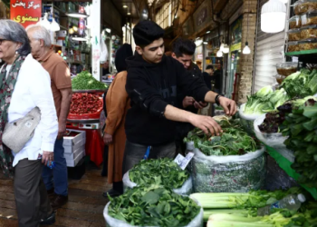 People shop at a market, amid the US-Israel conflict with Iran, in Tehran, Iran