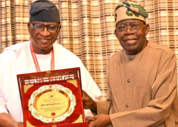 President Bola Tinubu presents a commemorative plaque to a recipient during a presentation ceremony at the Presidential Villa, Abuja.