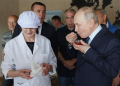 Russian President Vladimir Putin samples red caviar during his visit to the Yasny fish processing complex on Iturup, one of the disputed Kuril Islands.