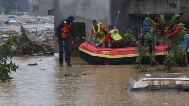 Rescue teams search for missing people and assess the destruction caused by flash floods in Nepal