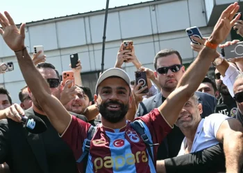 Egyptian forward Mohamed Salah gestures as he arrives at Istanbul Ataturk Airport to complete his transfer to Turkish football club Trabzonspor