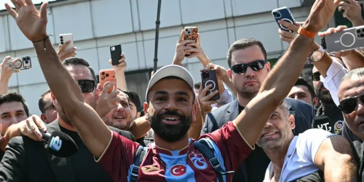 Egyptian forward Mohamed Salah gestures as he arrives at Istanbul Ataturk Airport to complete his transfer to Turkish football club Trabzonspor