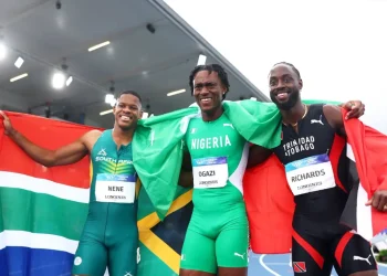 Nigeria's Samuel Ogazi (middle) celebrates after winning the 2026 Commonwealth Games 400 metres gold medal
