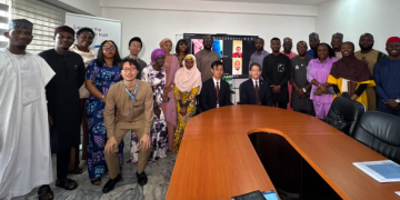 JICA officials, scholarship beneficiaries and other participants pose for a group photograph during a scholarship orientation and send-off ceremony in Abuja