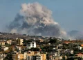 Smoke rises following an Israeli-controlled explosion in the village of Kfartibnit, as seen from Nabatieh in southern Lebanon