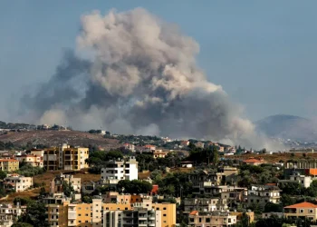 Smoke rises following an Israeli-controlled explosion in the village of Kfartibnit, as seen from Nabatieh in southern Lebanon
