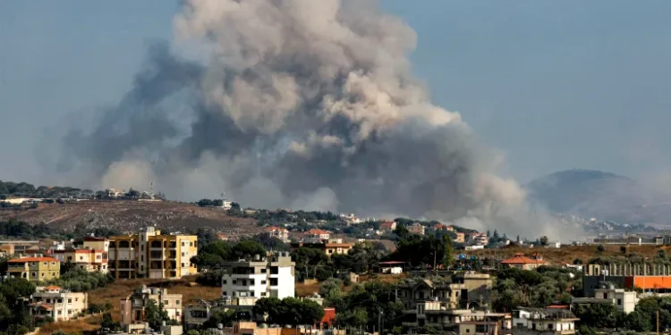 Smoke rises following an Israeli-controlled explosion in the village of Kfartibnit, as seen from Nabatieh in southern Lebanon