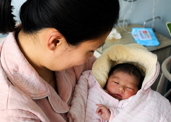 Tender mother and newborn cuddle