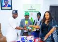 Deputy Governor Dennis Idahosa receives health insurance cards during the launch of Edo's health insurance programme in Benin.