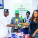 Deputy Governor Dennis Idahosa receives health insurance cards during the launch of Edo's health insurance programme in Benin.