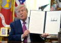 US President Donald Trump signs an executive order renaming Lake Ontario as “Lake America” at the White House, amid escalating tensions between the United States and Canada.