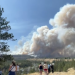 Thick smoke rises over Spokane, Washington, as wildfires force mass evacuations, destroy buildings and leave thousands without power.