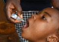 A child receives a polio vaccine during an immunization exercise to help protect against the disease.