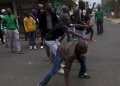 A group of foreign nationals threaten to defend themselves as police get between them and South Africans after a peace march in Durban