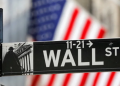 A street sign for Wall Street is seen outside the New York Stock Exchange, NYSE, in New York City, New York, United States