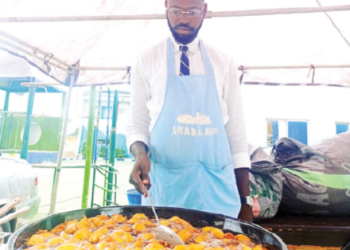 Akara vendor at the maiden International Akara Day Festival in Abuja, where the traditional Nigerian bean cake is celebrated as part of efforts to promote indigenous food culture and support grassroots entrepreneurs.