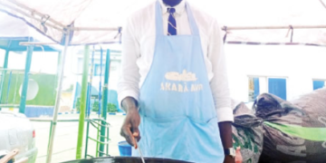 Akara vendor at the maiden International Akara Day Festival in Abuja, where the traditional Nigerian bean cake is celebrated as part of efforts to promote indigenous food culture and support grassroots entrepreneurs.