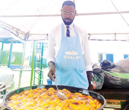 Akara vendor at the maiden International Akara Day Festival in Abuja, where the traditional Nigerian bean cake is celebrated as part of efforts to promote indigenous food culture and support grassroots entrepreneurs.