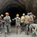 Army personnel have resorted to using explosives to blast into the hillside to reach the trapped workers
