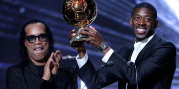 Ousmane Dembélé poses with the 2025 Ballon d’Or after winning the prestigious individual award, as the Paris Saint-Germain forward earns a place on the 30-man shortlist alongside eight other PSG stars for the 2026 prize.