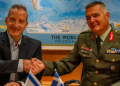 Director General of the Israel Ministry of Defence Maj Gen Amir Baram and his Greek counterpart, Ioannis Bouras, shake hands as they sign a defence deal in Tel Aviv