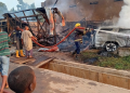 Firefighters work to contain a gas fire at an outlet near Liberty Junction in Kubwa, Abuja, after a vehicle reportedly crashes into the facility, triggering an explosion and damaging nearby shops and a traffic post.