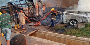 Firefighters work to contain a gas fire at an outlet near Liberty Junction in Kubwa, Abuja, after a vehicle reportedly crashes into the facility, triggering an explosion and damaging nearby shops and a traffic post.