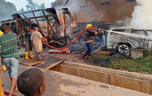 Firefighters work to contain a gas fire at an outlet near Liberty Junction in Kubwa, Abuja, after a vehicle reportedly crashes into the facility, triggering an explosion and damaging nearby shops and a traffic post.