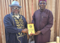 Former Chief of Army Staff, retired Lt.-Gen. Tukur Buratai, receives a plaque from officials of the Defence Correspondents Association of Nigeria (DECAN) during their courtesy visit in Abuja