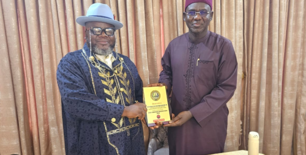 Former Chief of Army Staff, retired Lt.-Gen. Tukur Buratai, receives a plaque from officials of the Defence Correspondents Association of Nigeria (DECAN) during their courtesy visit in Abuja