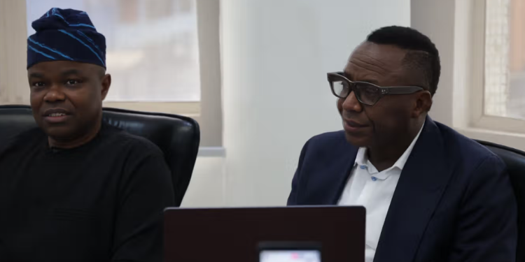 Olumide Fusika with Sowore during the press briefing