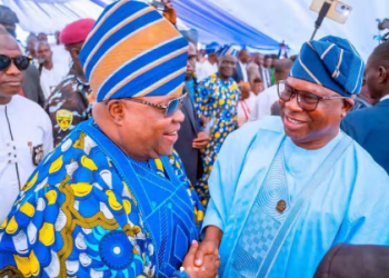 Osun State Governor Ademola Adeleke shakes hands with Bola Oyebamiji during a public event, as Oyebamiji’s legal team denies authorizing a petition challenging Adeleke’s victory in the August 15 governorship election.