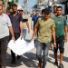 Palestinians carry the body of three-year-old Saadi Ghalia, who was killed by an Israeli tank shell