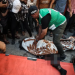 People tend to the deceased after an Israeli strike targeted a group of Palestinians in Gaza City on Thursday