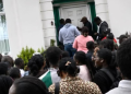 Nigerians gather at a passport intervention centre in the UK