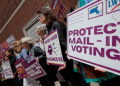 Supporters gather outside a federal courthouse in Boston, Massachusetts, during a legal challenge to President Donald Trump’s executive order tightening rules on mail-in voting.