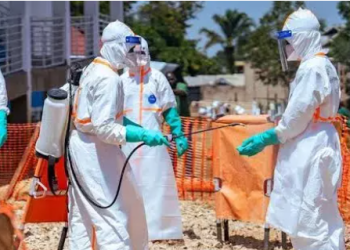 Healthcare workers in full personal protective equipment undergo disinfection at an Ebola treatment and response centre as health authorities intensify efforts to contain the outbreak in the Democratic Republic of the Congo and prevent further regional spread.