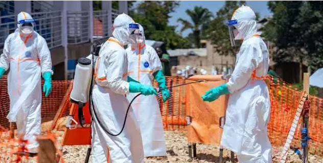 Healthcare workers in full personal protective equipment undergo disinfection at an Ebola treatment and response centre as health authorities intensify efforts to contain the outbreak in the Democratic Republic of the Congo and prevent further regional spread.