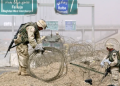 US troops clear rolls of razor wire from the main entrance to Fallujah, Iraq