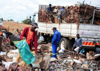 Scrap-metal dealers sorting metal scrap at a scrapyard